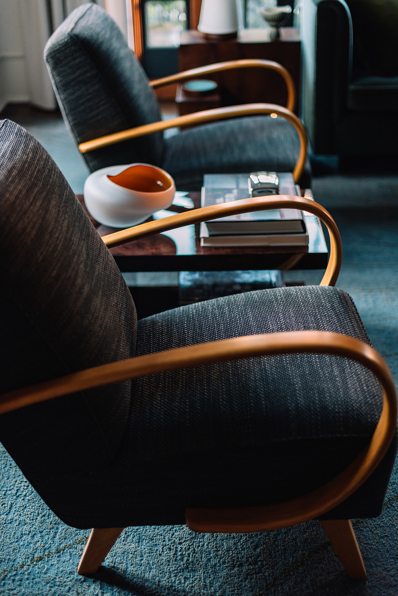 Upholstered armchairs and curved timber arms
