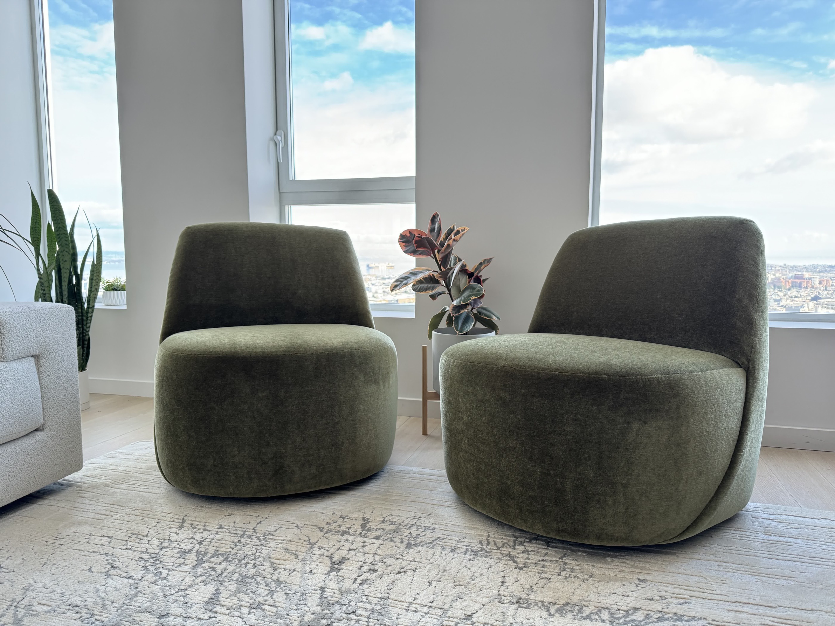Pair of rounded green upholstered chairs